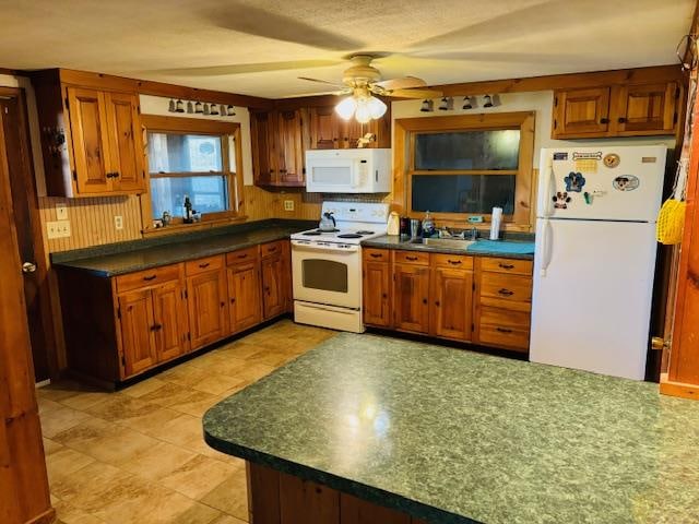 kitchen with ceiling fan, decorative backsplash, and white appliances