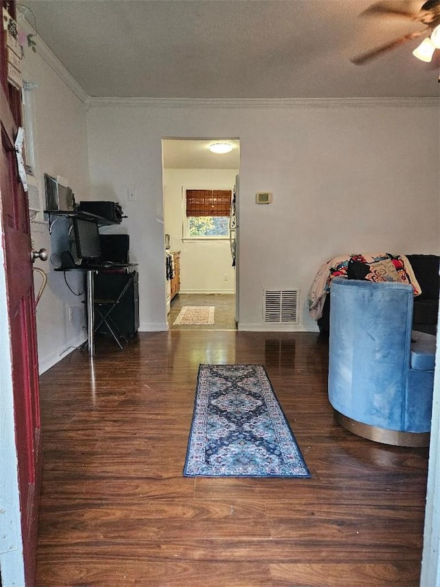 interior space featuring dark hardwood / wood-style flooring, ceiling fan, and crown molding