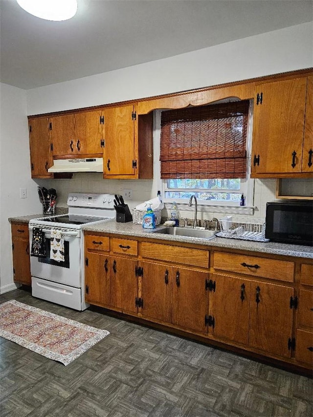 kitchen featuring dark parquet floors, tasteful backsplash, white range with electric stovetop, and sink