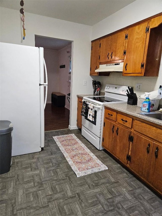 kitchen featuring white appliances and tasteful backsplash