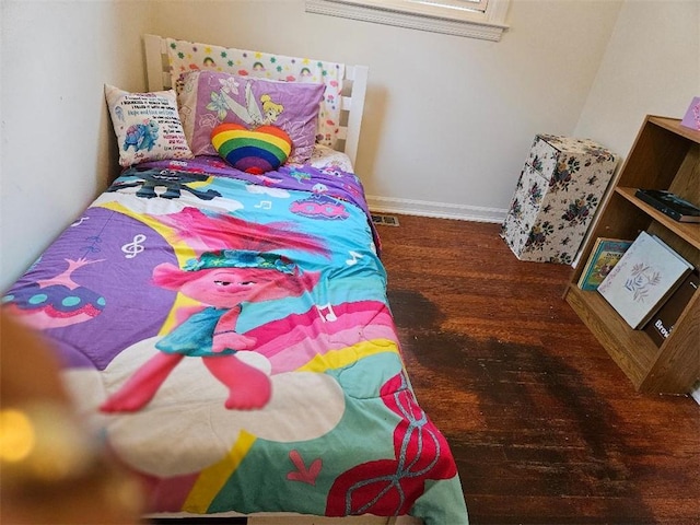 bedroom with dark hardwood / wood-style floors