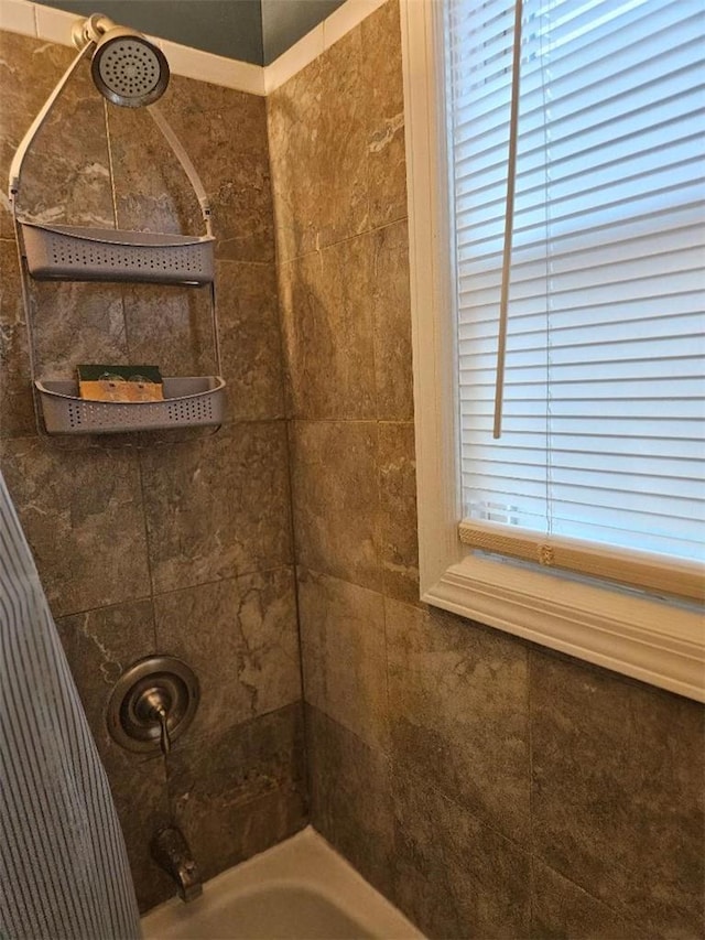 bathroom featuring tiled shower / bath