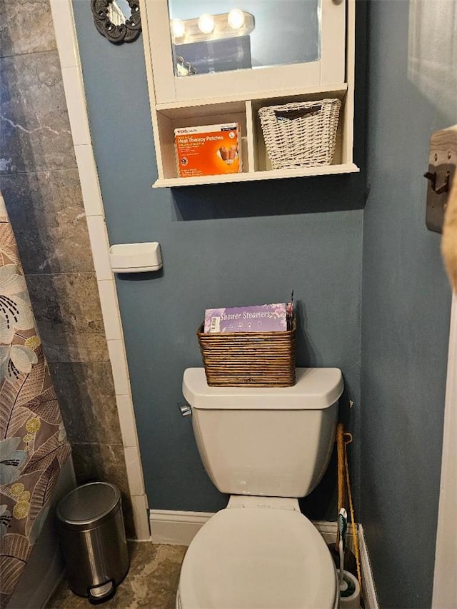 bathroom featuring toilet and walk in shower