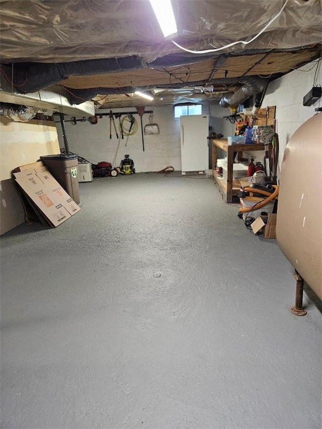 basement featuring white fridge