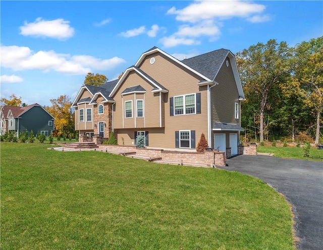 back of house with a yard and a garage