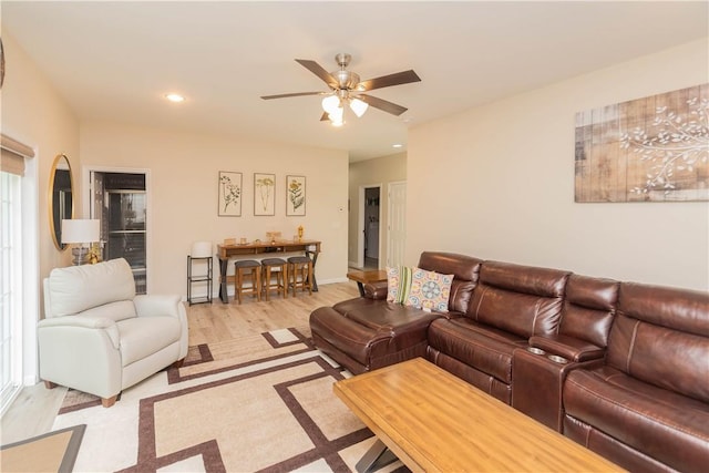 living room featuring light hardwood / wood-style floors and ceiling fan