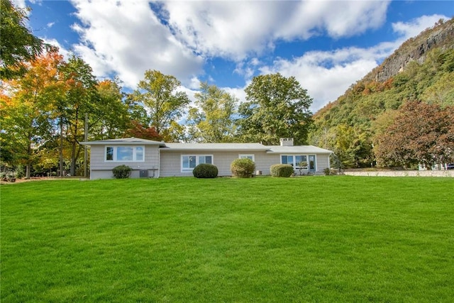 rear view of property featuring a yard