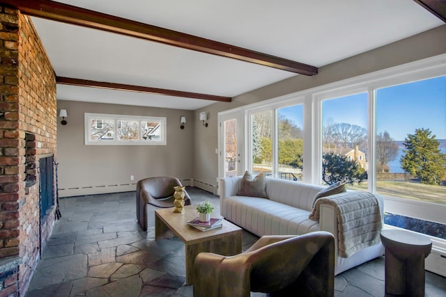 living room featuring beamed ceiling, a baseboard radiator, and a brick fireplace