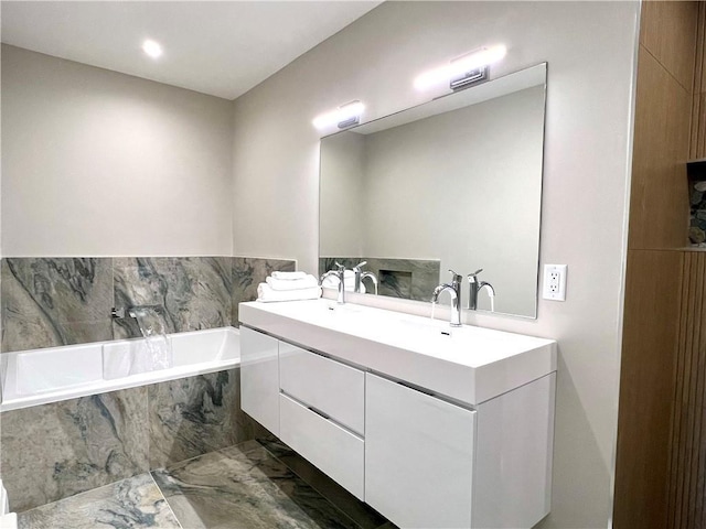 bathroom with vanity and a relaxing tiled tub