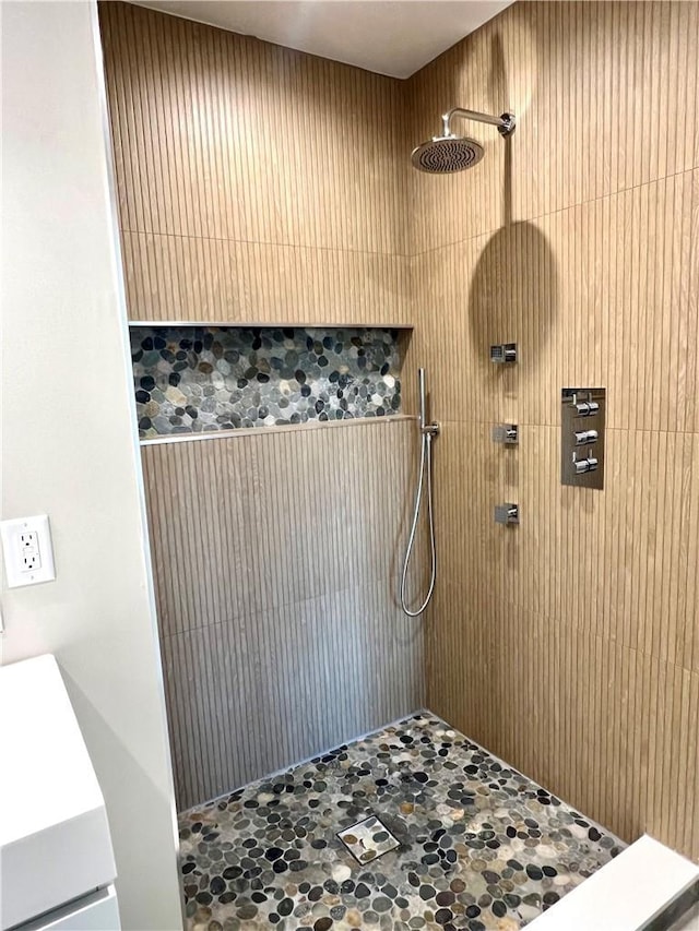 bathroom featuring vanity and tiled shower