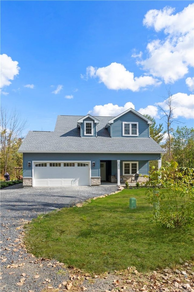 view of front of home featuring a front yard and a garage