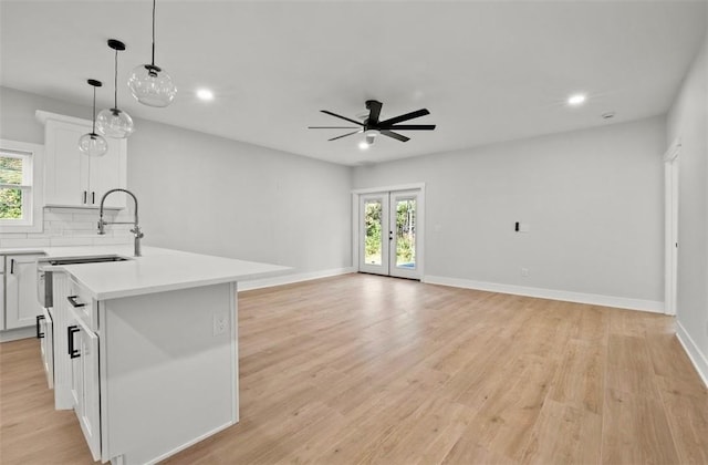 kitchen with plenty of natural light, a kitchen island, and white cabinetry