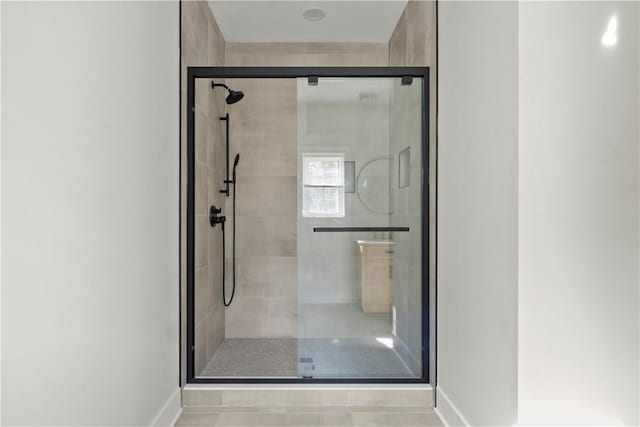 bathroom featuring a shower with shower door