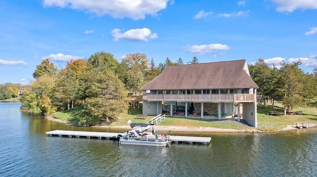 dock area featuring a water view and a lawn