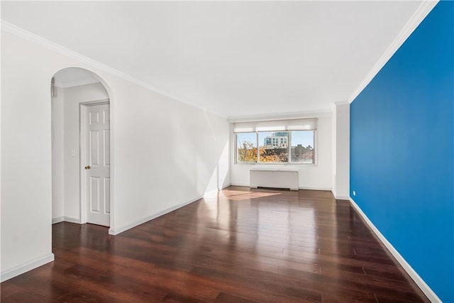 unfurnished living room featuring dark hardwood / wood-style flooring, radiator heating unit, and crown molding