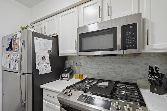 kitchen with tasteful backsplash, white cabinetry, and stainless steel appliances