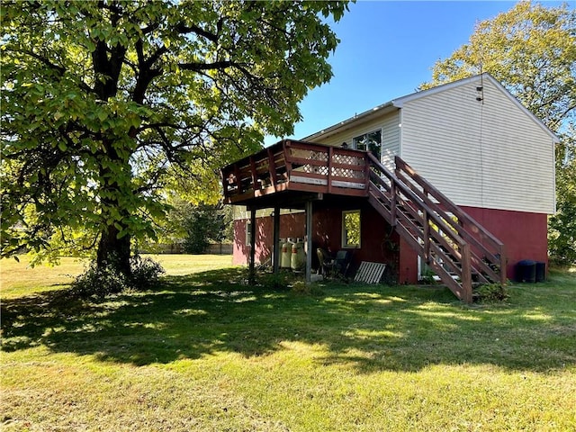 back of property with a lawn and a wooden deck