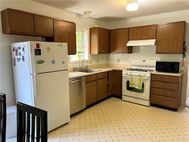 kitchen featuring white appliances and sink