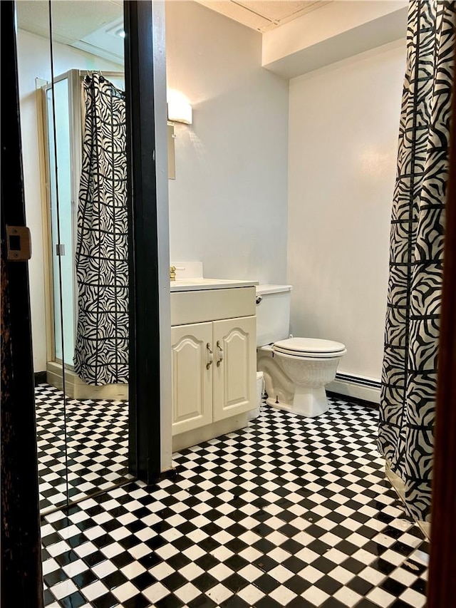 bathroom featuring vanity, toilet, walk in shower, and a baseboard radiator