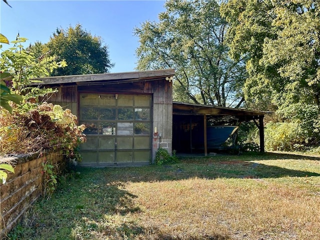 view of outdoor structure featuring a yard and a garage