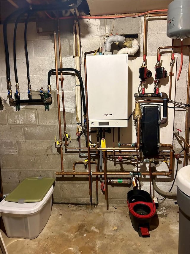 utility room featuring water heater