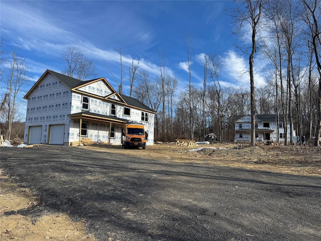 view of home's exterior with a porch and a garage