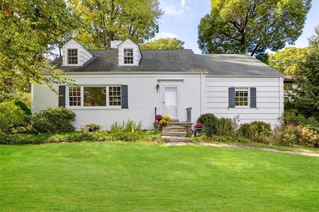 new england style home featuring a front yard