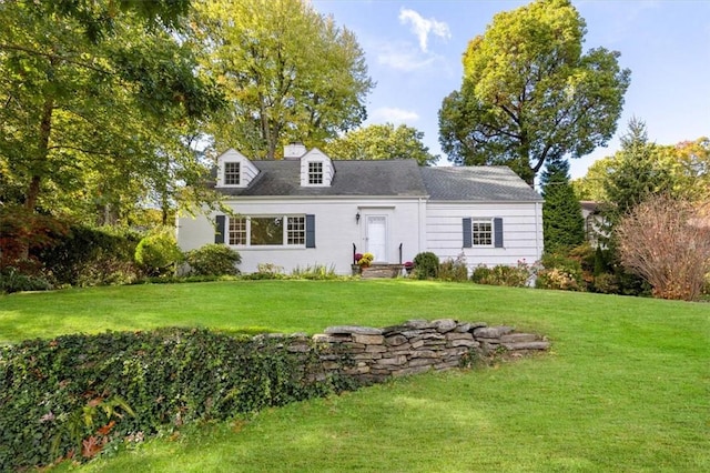 cape cod home with a front yard