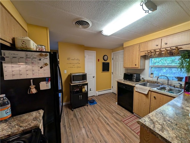 kitchen featuring sink, black appliances, a baseboard radiator, and light wood-type flooring