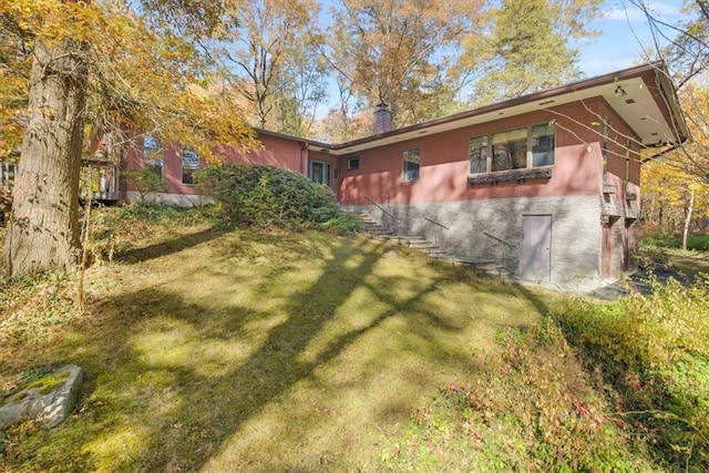 view of side of home featuring a lawn