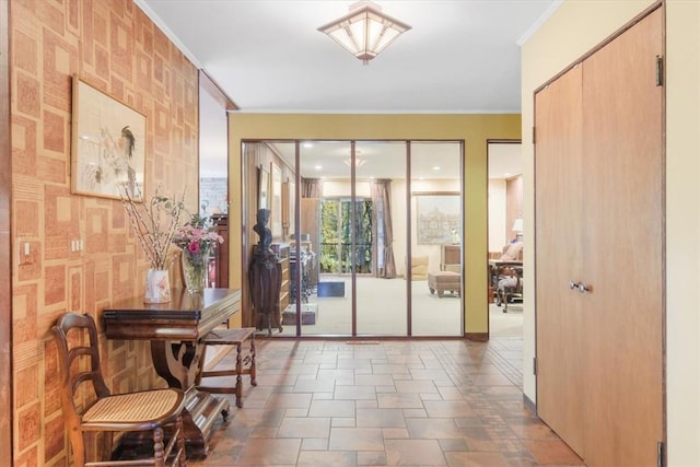 doorway to outside featuring crown molding