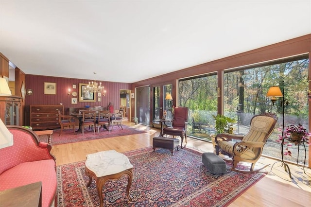 living room featuring an inviting chandelier and light hardwood / wood-style flooring