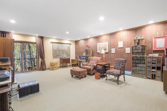 living room featuring carpet floors and wood walls