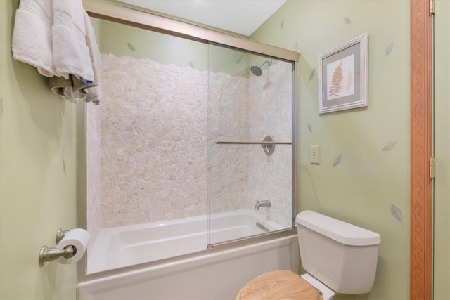 bathroom with bath / shower combo with glass door and toilet