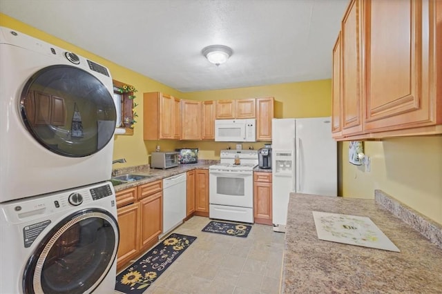 kitchen featuring sink, white appliances, stacked washer and dryer, and light brown cabinetry