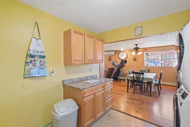 kitchen featuring a wall mounted AC, ceiling fan, light hardwood / wood-style flooring, and white refrigerator