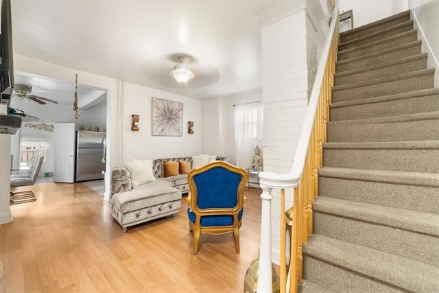 living room featuring hardwood / wood-style floors, ceiling fan, and a wealth of natural light