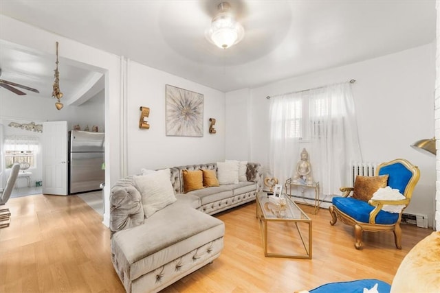 living room featuring a wealth of natural light, ceiling fan, and wood-type flooring