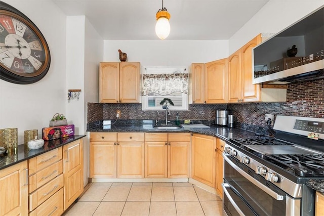 kitchen featuring sink, light brown cabinets, stainless steel appliances, tasteful backsplash, and pendant lighting