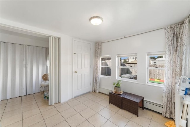 tiled entryway featuring baseboard heating