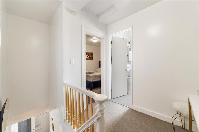 corridor featuring light colored carpet