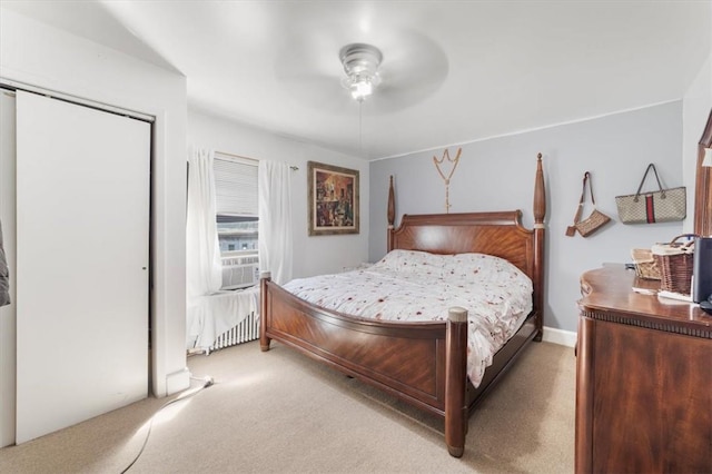 carpeted bedroom featuring a closet and ceiling fan