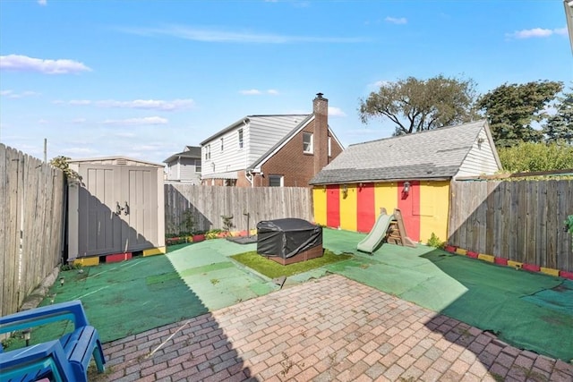 view of patio featuring a storage unit