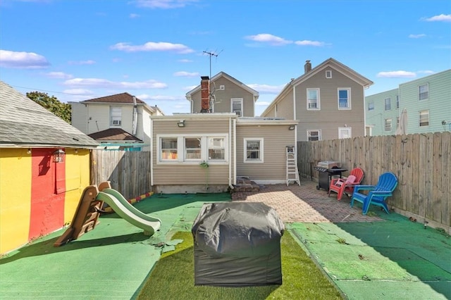 rear view of house with a yard and a patio