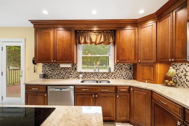 kitchen featuring dishwasher, decorative backsplash, and sink