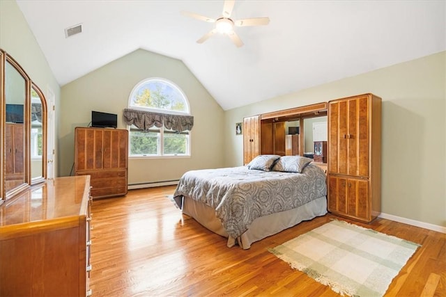 bedroom featuring baseboard heating, ceiling fan, light hardwood / wood-style floors, and lofted ceiling