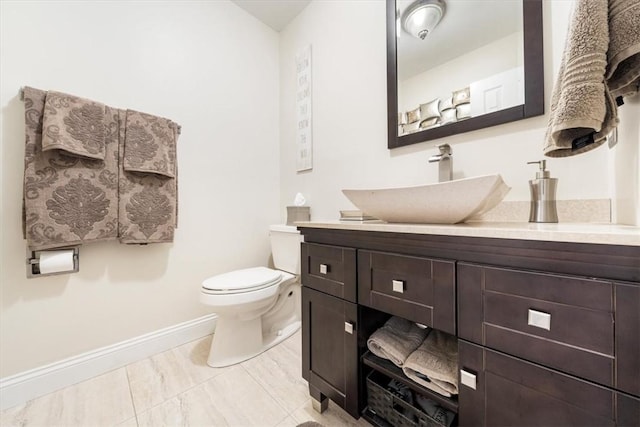 bathroom featuring tile patterned floors, vanity, and toilet