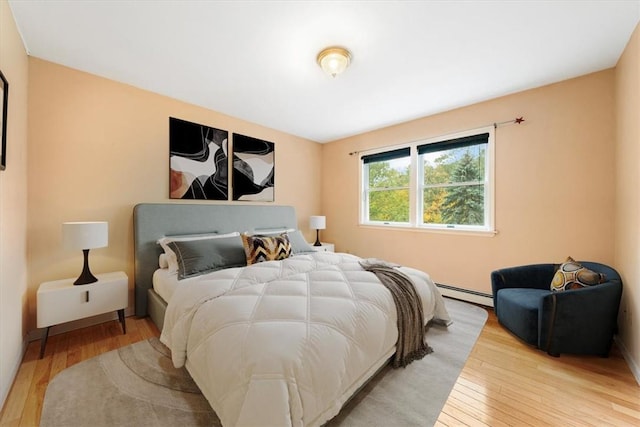 bedroom featuring light hardwood / wood-style floors and a baseboard radiator