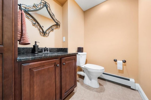 bathroom with baseboard heating, tile patterned flooring, vanity, and toilet