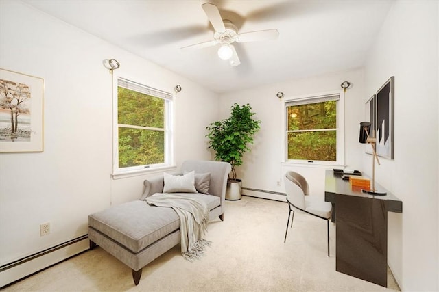 interior space with ceiling fan, light colored carpet, and a baseboard heating unit